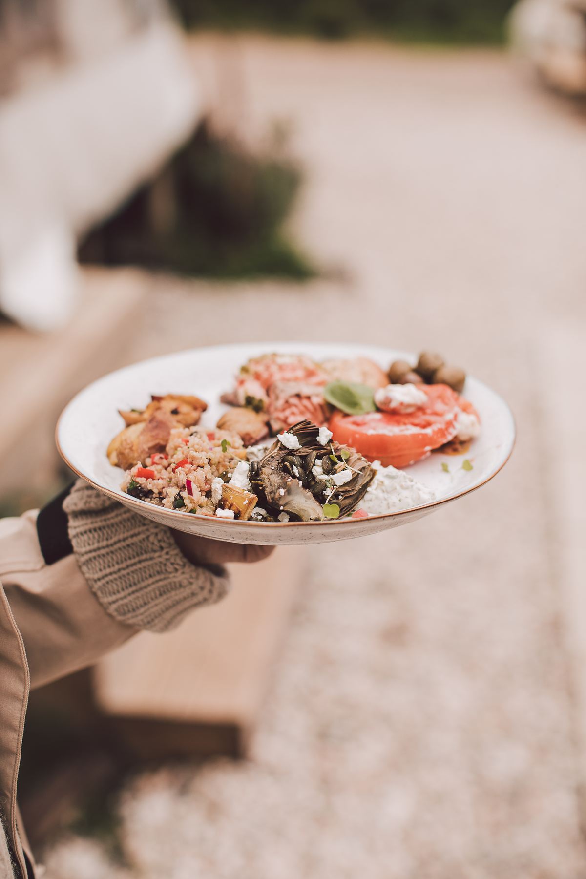 A plate of fresh seasonal food held in two hands